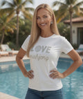 Woman wearing LOVE Mahjong in White short sleeve tee by the pool.
