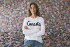 Woman wearing a white sweatshirt with 'Canasta' text in front of a patterned wall.