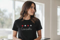 Woman wearing a black t-shirt with Canasta design indoors