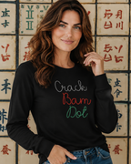 Woman wearing a black longsleeve with  crack bam dottext in front of a wall with Chinese characters