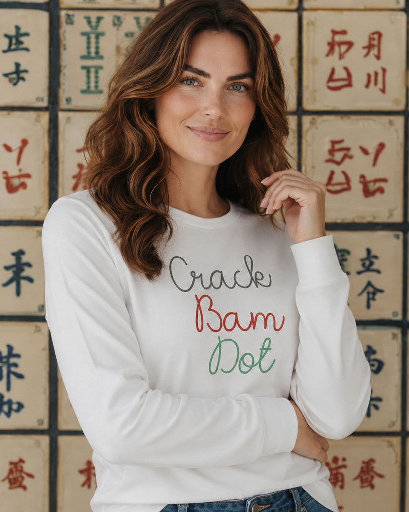 Woman wearing a white longsleeve with  crack bam dottext in front of a wall with Chinese characters