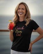Woman wearing short sleeve tee in black with crack bam dot design, standing and holding a mocktail.