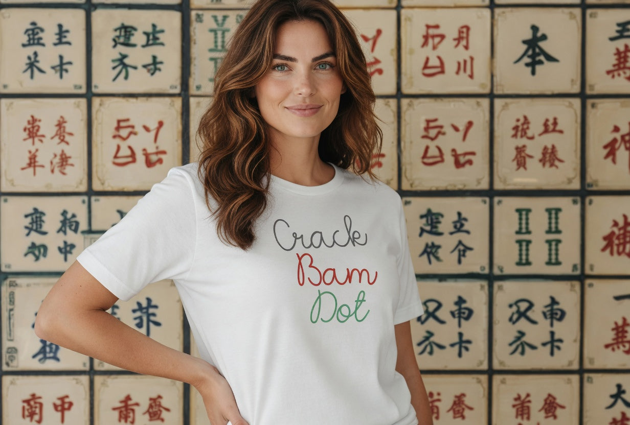 Woman wearing a white t-shirt with 'Crack Bam Dot' text in front of a wall with Chinese characters.