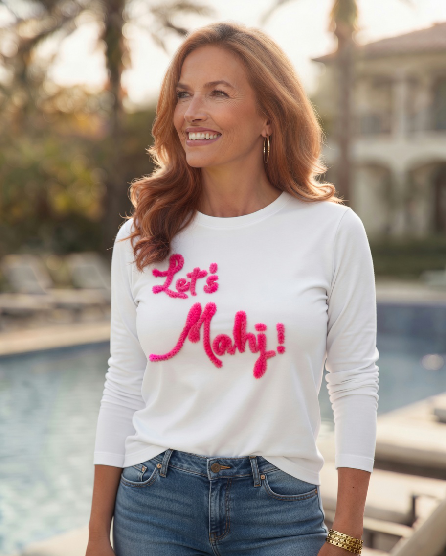 Woman wearing white long sleeve in lets mahj chenille design by the pool.