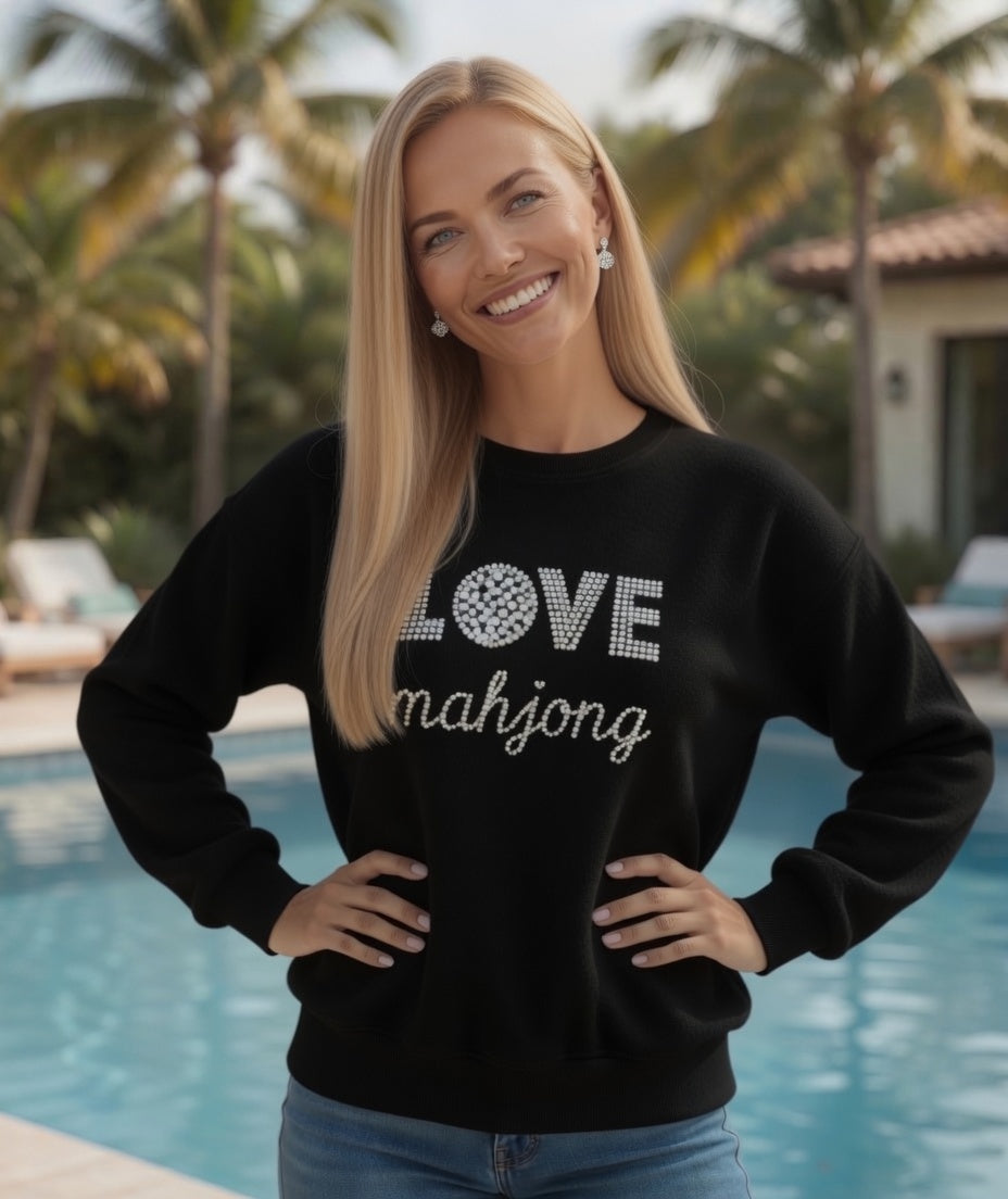 Women wearing LOVE Mahjong white sweatshirt by the pool