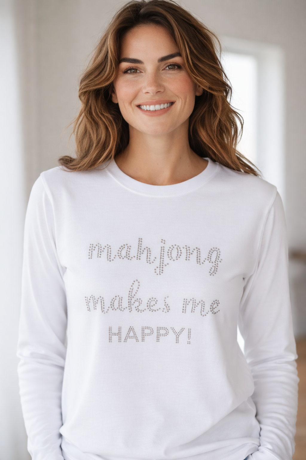 Woman wearing a white long-sleeve shirt with 'mahjong makes me HAPPY!' text.