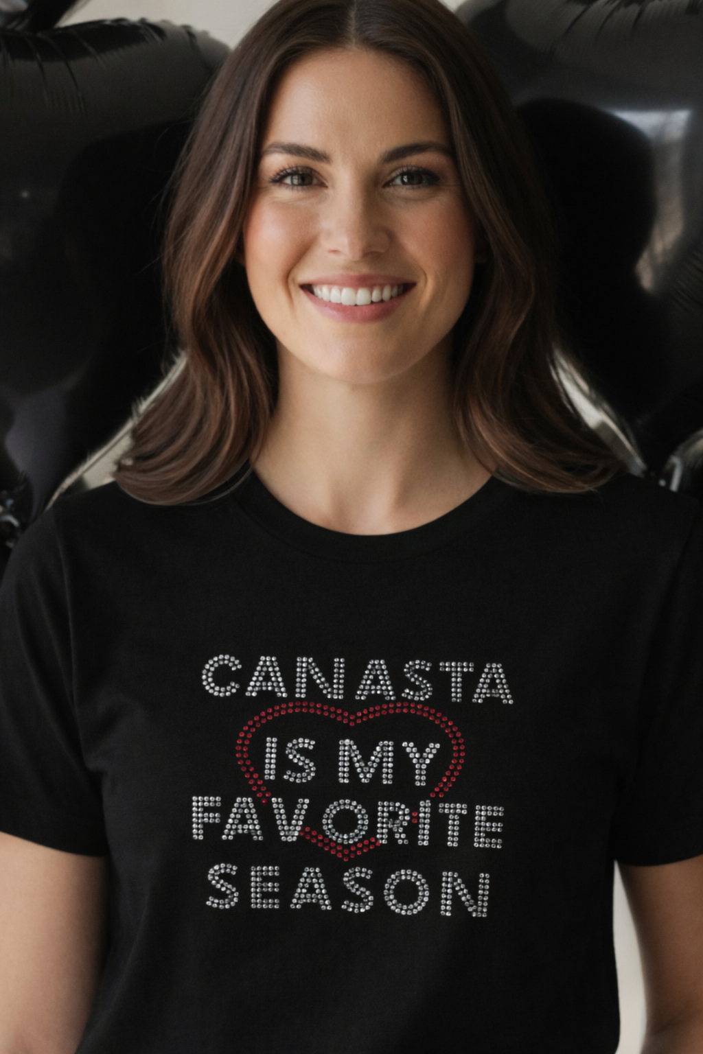 Woman wearing a black t-shirt with 'Canasta is my favorite season' text.